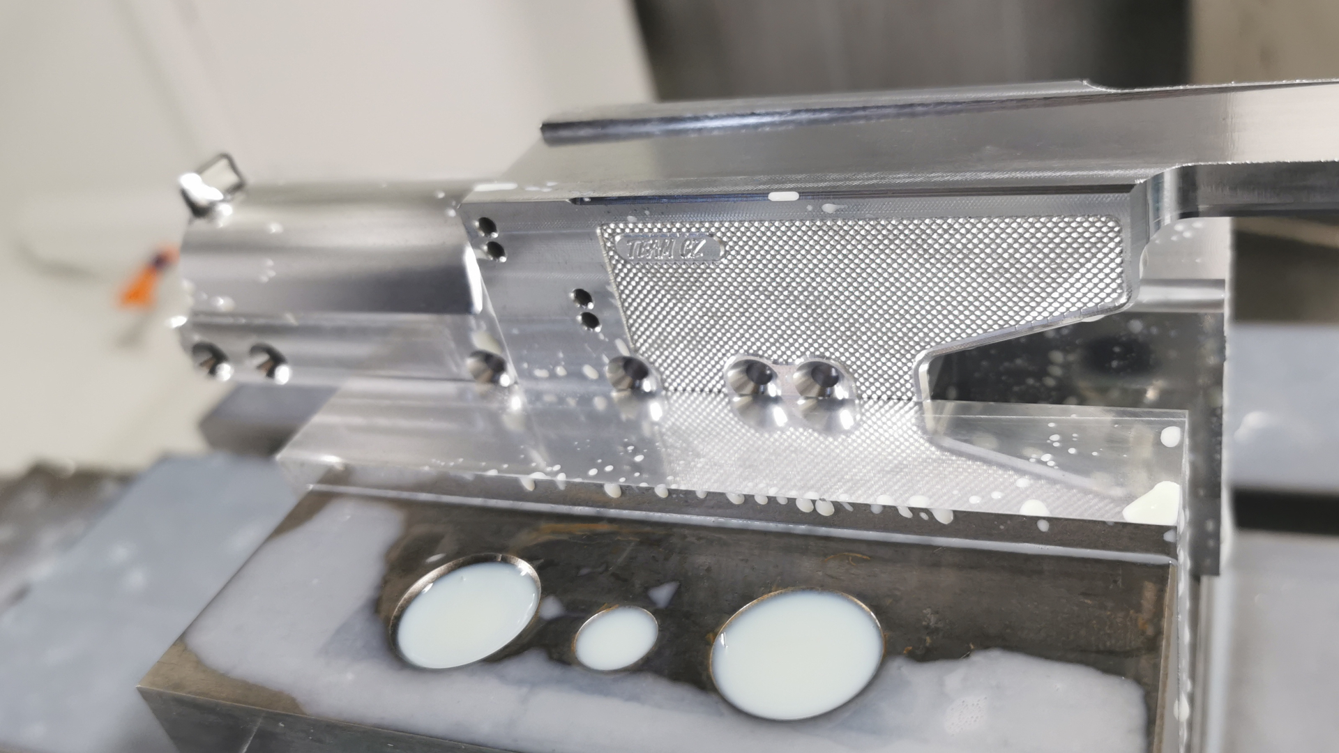 Custom sport pistol frame mounted to CNC machine